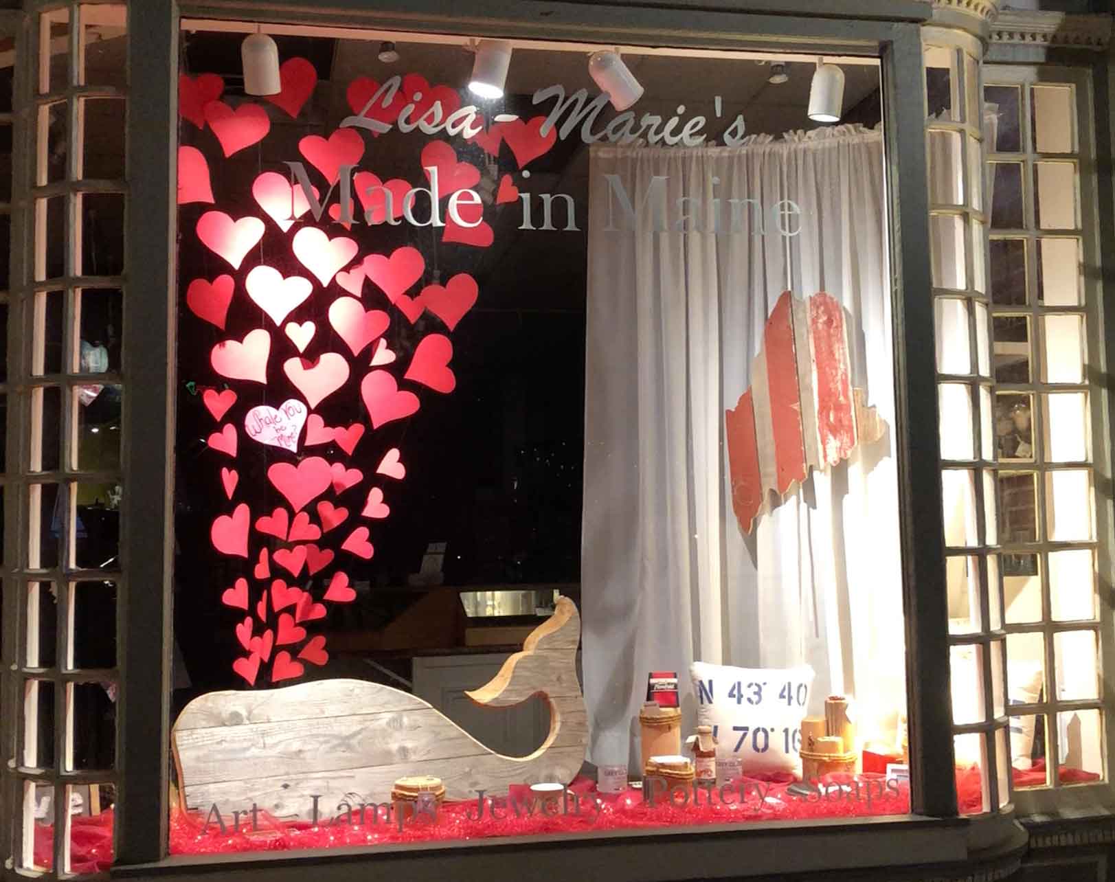 Whale You Be Mine? Portland Storefront Window February 2018. A wooden whale with hearts being pushed from his blow hole.
