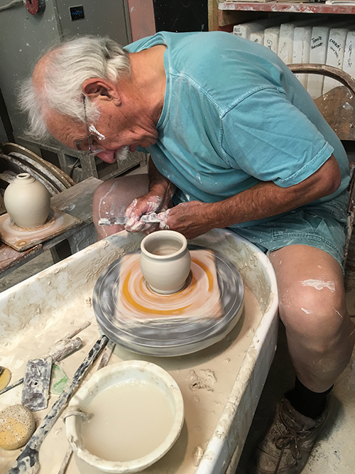 Joe Devenney throwing pottery